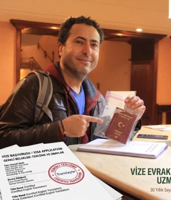 Kemal Kaya vize evrakları ve yeminli tercüme dosyalarını hazırlarken.